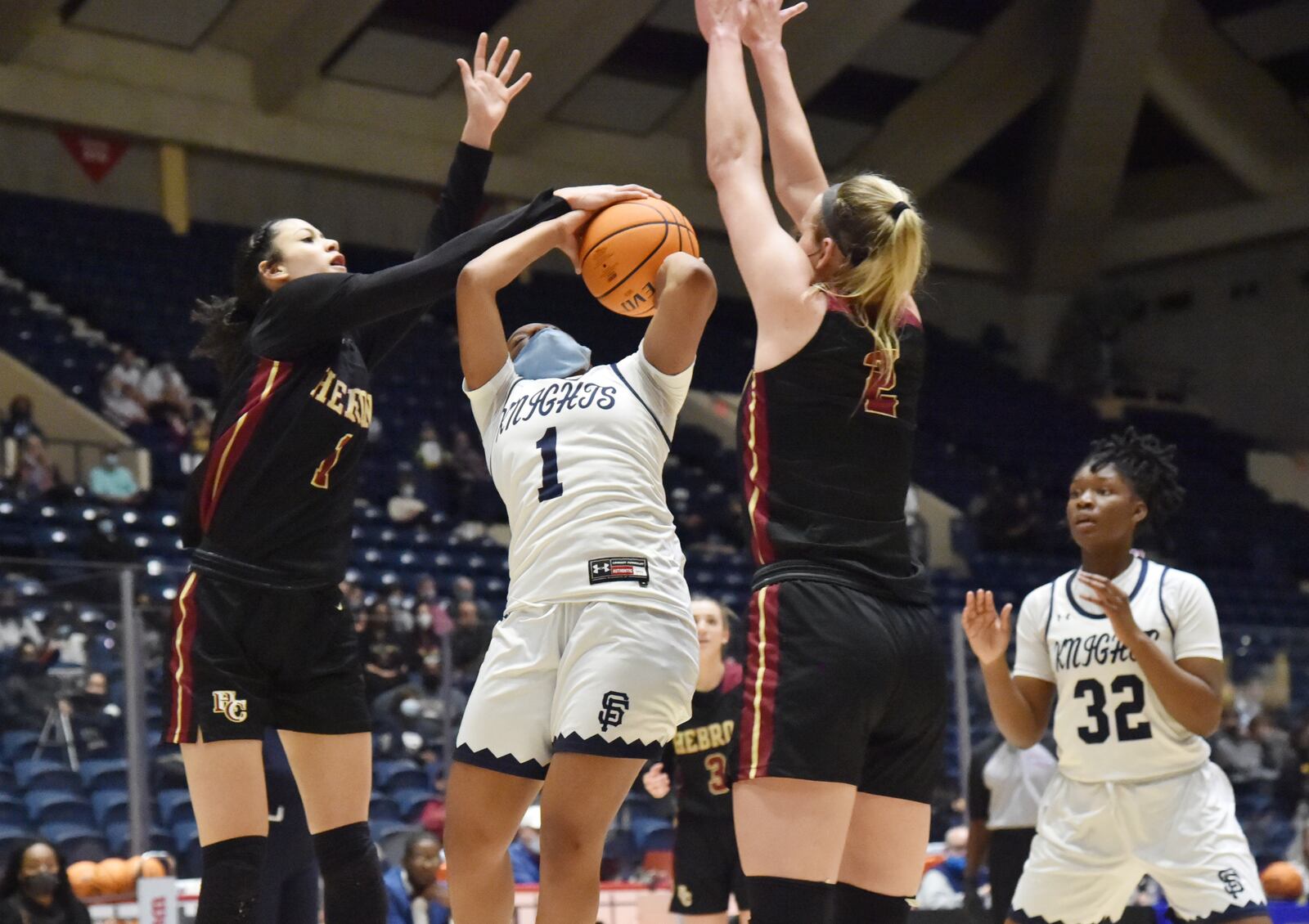 Hebron Christian's Malia Fisher (1) blocks a shot by St. Francis' Morgan Harper (1) during the Class A Private girls basketball championship game Wednesday, March 10, 2021, at the Macon Centreplex in Macon. (Hyosub Shin / Hyosub.Shin@ajc.com)