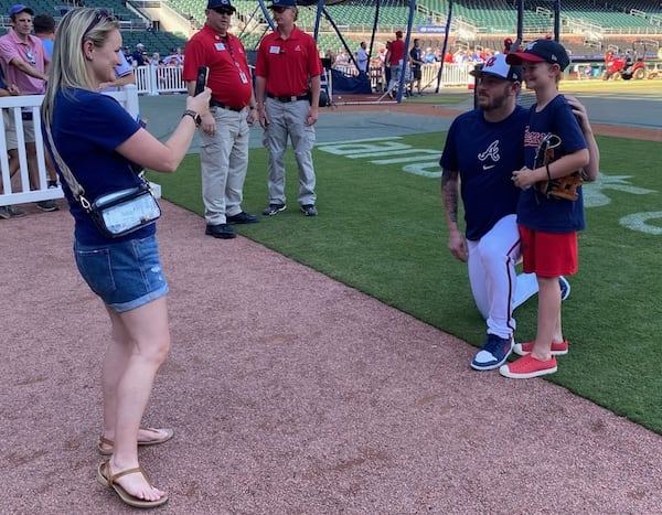 Braves pitcher Tyler Matzek poses for a photo with 10-year-old Bryson Vaughan for Bryson's mother Amber prior to the Braves-Nationals game May 30, 2024 at Truist Park. Bryson has had challenge with anxiety and was invited to the field by Matzek, who has been public about his own mental-health challenges. (AJC photo by Ken Sugiura)