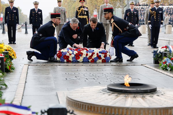 French President Emmanuel Macron, center right, and Britain's Prime Minister Keir Starmer lay a wreath at the Tomb of the Unknown Soldier during commemorations marking the 106th anniversary of the November 11, 1918, Armistice, ending World War I, in Paris, Monday, Nov. 11, 2024. ( Ludovic Marin, Pool via AP)