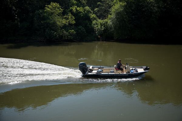 Chattahoochee Riverkeeper Executive Director Jason Ulseth scours the river for irregularities during a boat patrol ride with the organization on June 12, 2024. (Riley Bunch/AJC)