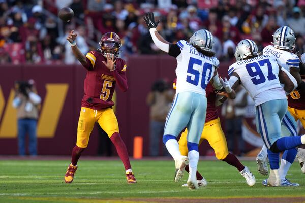 Washington Commanders quarterback Jayden Daniels (5) passes during the second half of an NFL football game against the Dallas Cowboys, Sunday, Nov. 24, 2024, in Landover, Md. (AP Photo/Stephanie Scarbrough)