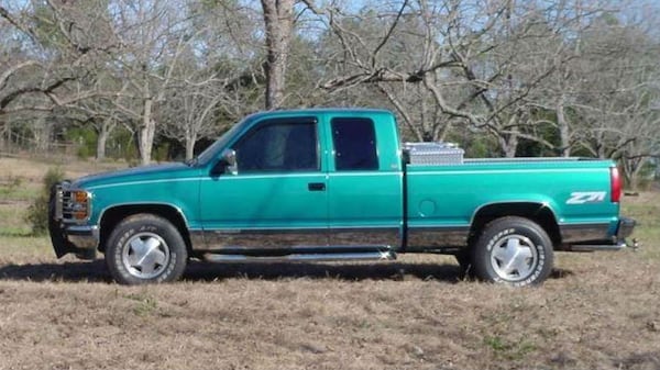 A person of interest in the Houston "Jane Doe" case was seen in early March getting out of a Chevy Silverado extended cab truck similar to the one pictured and throwing a black plastic bag off a bridge near where the victim's severed head was found March 24. The suspicious truck was beaten up and rusty, with a broken rear driver's side window covered with cardboard.