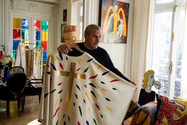 Designer Jean-Charles de Castelbajac displays a liturgical vestment for priests and to be worn at the reopening of Paris' Notre-Dame Cathedral in December, Wednesday, Nov. 20, 2024 in Paris. (AP Photo/Michel Euler)