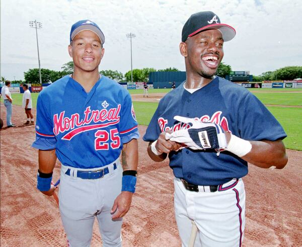 Newly acquired Braves outfielder Marquis Grissom jokes with new Expos player and former Braves Tony Tarasco as they wait for their picture to be taken by Sports Illustrated photographer Tom DiPace at West Palm Beach Municipal Stadium in April of 1995.