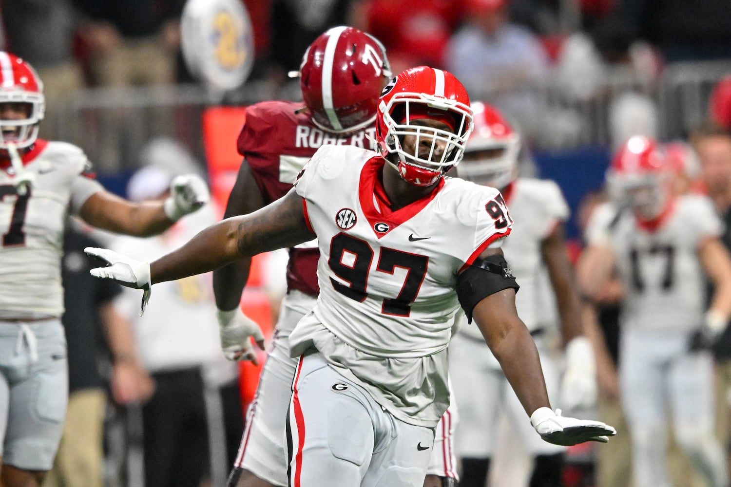 Georgia Bulldogs defensive lineman Warren Brinson (97) reacts after tackling Alabama Crimson Tide quarterback Jalen Milroe during the first half of the SEC Championship football game at the Mercedes-Benz Stadium in Atlanta, on Saturday, December 2, 2023. (Hyosub Shin / Hyosub.Shin@ajc.com)