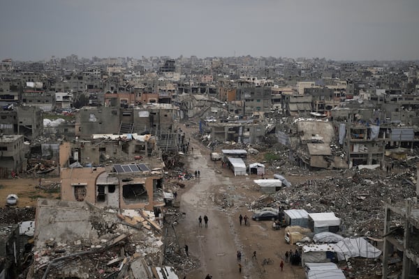 Palestinians walk surrounded by the rubble of destroyed homes and building in the Zeitoun neighborhood of Gaza City, Friday, March 7, 2025. (AP Photo/Jehad Alshrafi)