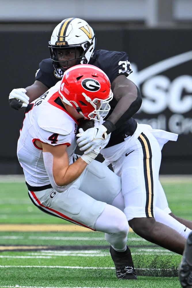 Georgia tight end Oscar Delp (4) is brought down. y Vanderbilt defensive back BJ Diakite (33) during the second half of an NCAA football game, Saturday, Oct. 14, 2023, in Nashville, Tenn. (Special to the AJC/John Amis)