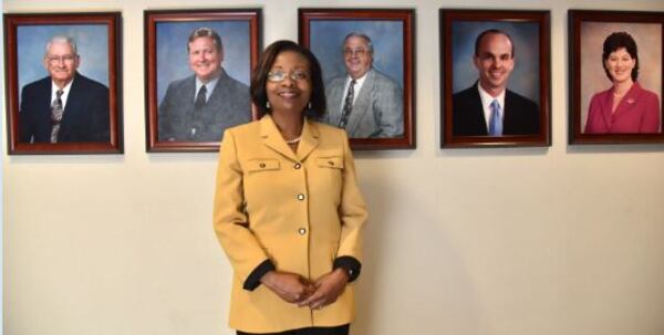 Portrait of newly elected Henry County Commission Chair June Wood in front of photographs of previous chairs of the Board of Commissioners. HYOSUB SHIN / HSHIN@AJC.COM