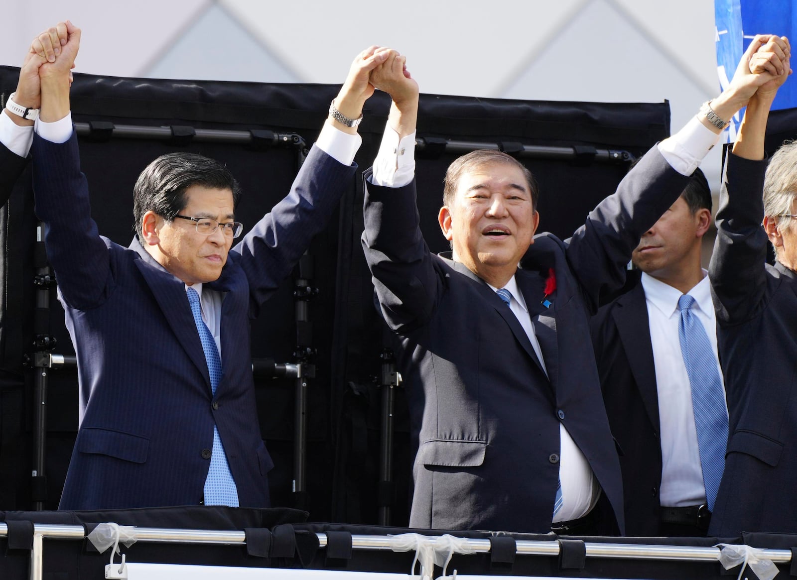 Japanese Prime Minister Shigeru Ishiba, second left, and Keiichi Ishii of the Komeito Party, during an election campaign in Soka, Saitama prefecture, on Oct. 13, 2024. (Kyodo News via AP)