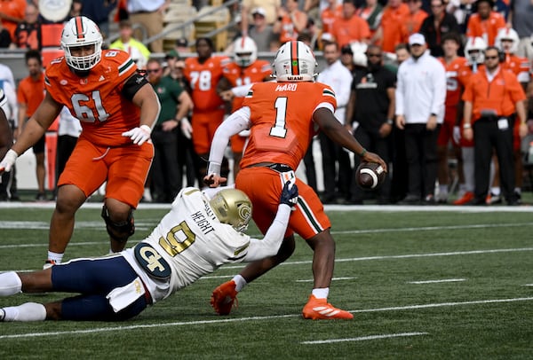 Georgia Tech defensive lineman Romello Height (9) sacks Miami quarterback Cam Ward (1) during the second half of an NCAA college football game at Georgia Tech's Bobby Dodd Stadium, Saturday, November 9, 2024, in Atlanta. Georgia Tech won 28-23 over Miami. (Hyosub Shin / AJC)