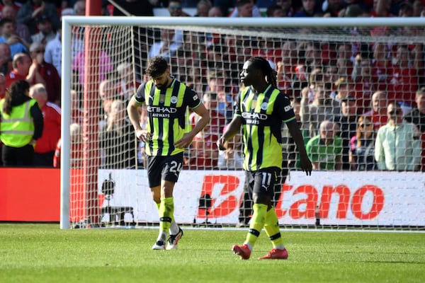 Manchester City's Josko Gvardiol, left, and Jeremy Doku react after Nottingham Forest's Callum Hudson-Odoi scoring opening goal during the English Premier League soccer match between Nottingham Forest and Manchester City at the City Ground stadium, in Nottingham, England, Saturday, March 8, 2025. (AP Photo/Rui Vieira)