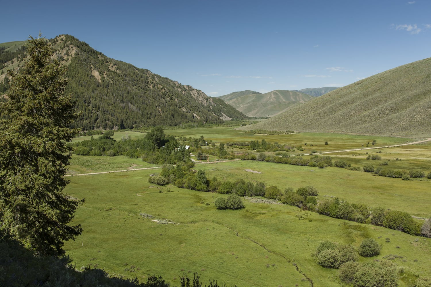 500-acre property has log cabins, mountain views