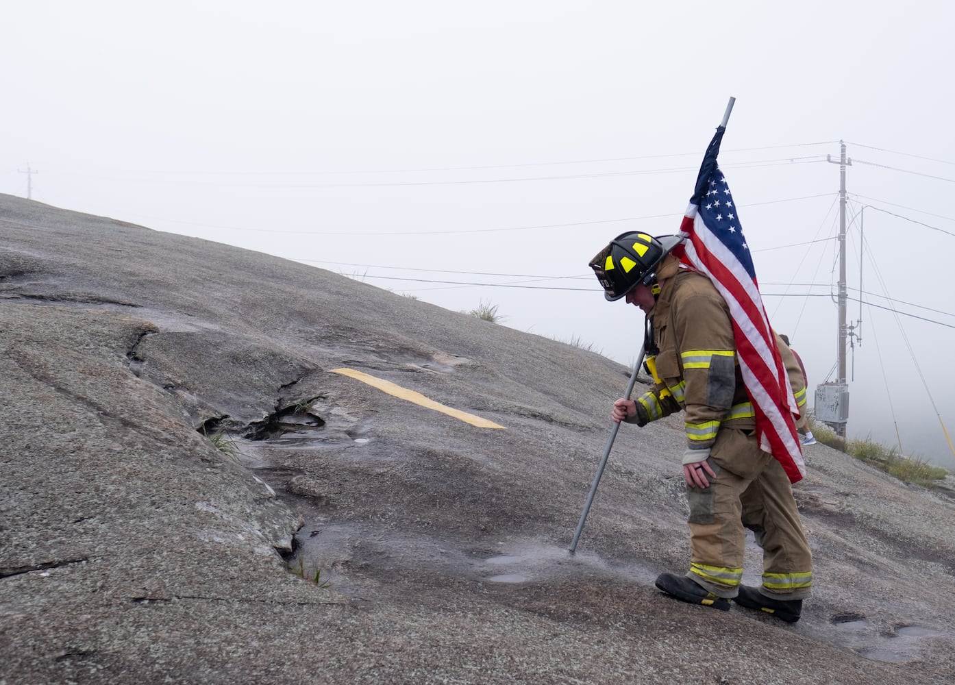 Fayetteville Firefighter Connor McKinlay pauses to catch his breath as he crests Stone Mountain on Sunday morning, Sept. 11, 2022, during the annual remembrance of the 9/11 terrorist attacks. (Photo: Ben Gray for The Atlanta Journal-Constitution)