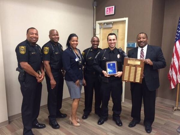 Officer P. J. Larscheid (holding blue plaque) was named Officer of the Year for 2014 and was honored by the North Decatur Lions Club. (Dekalb County Police Department / Facebook)