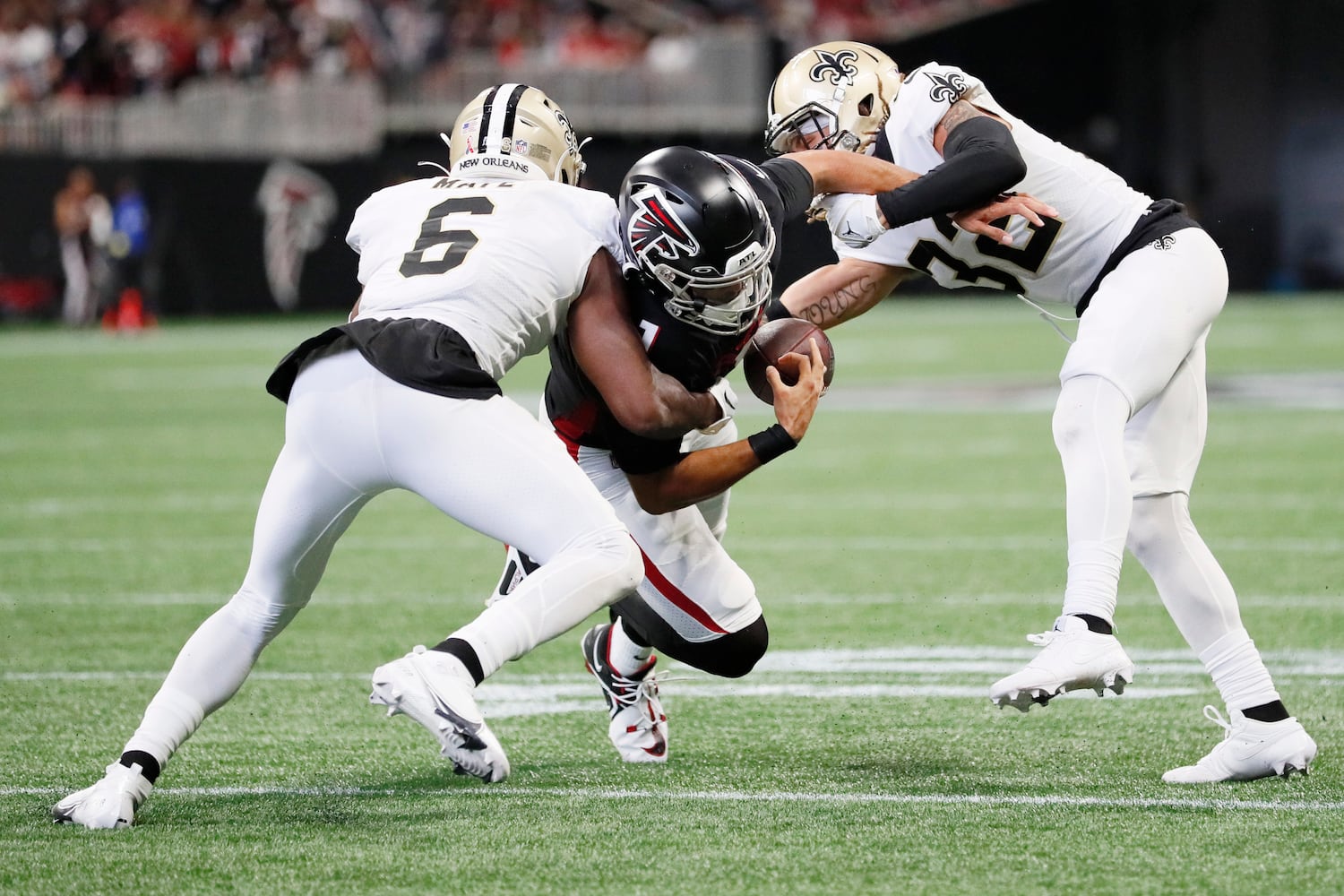 Saints safety Marcus Maye (6) and Saints safety Tyrann Mathieu hit Falcons quarterback Marcus Mariota (1) during the third quarter Sunday. (Miguel Martinez / miguel.martinezjimenez@ajc.com)