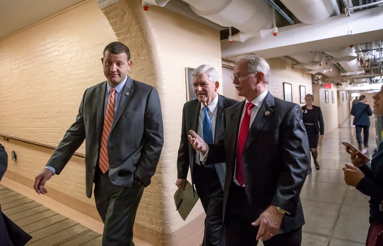 FILE - Rep. David Valadao, from left, R-Calif., Rep. Daniel Webster, R-Fla., and Rep. John Rutherford, R-Fla., walk to a closed-door GOP strategy session at the Capitol in Washington, Tuesday, June 26, 2018. (AP Photo/J. Scott Applewhite, File)