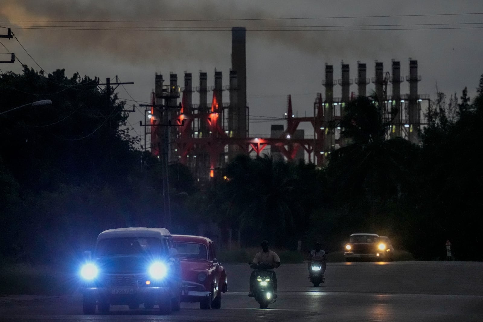 FILE - People drive their vehicles past a floating generator in operation, in Havana, Cuba, Oct. 22, 2024. (AP Photo/Ramon Espinosa, File)