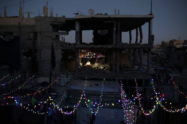 Palestinians hang decorations next to their destroyed homes in preparation for the holy month of Ramadan in Khan Younis, southern Gaza Strip, Friday, Feb. 28, 2025. (AP Photo/Jehad Alshrafi)