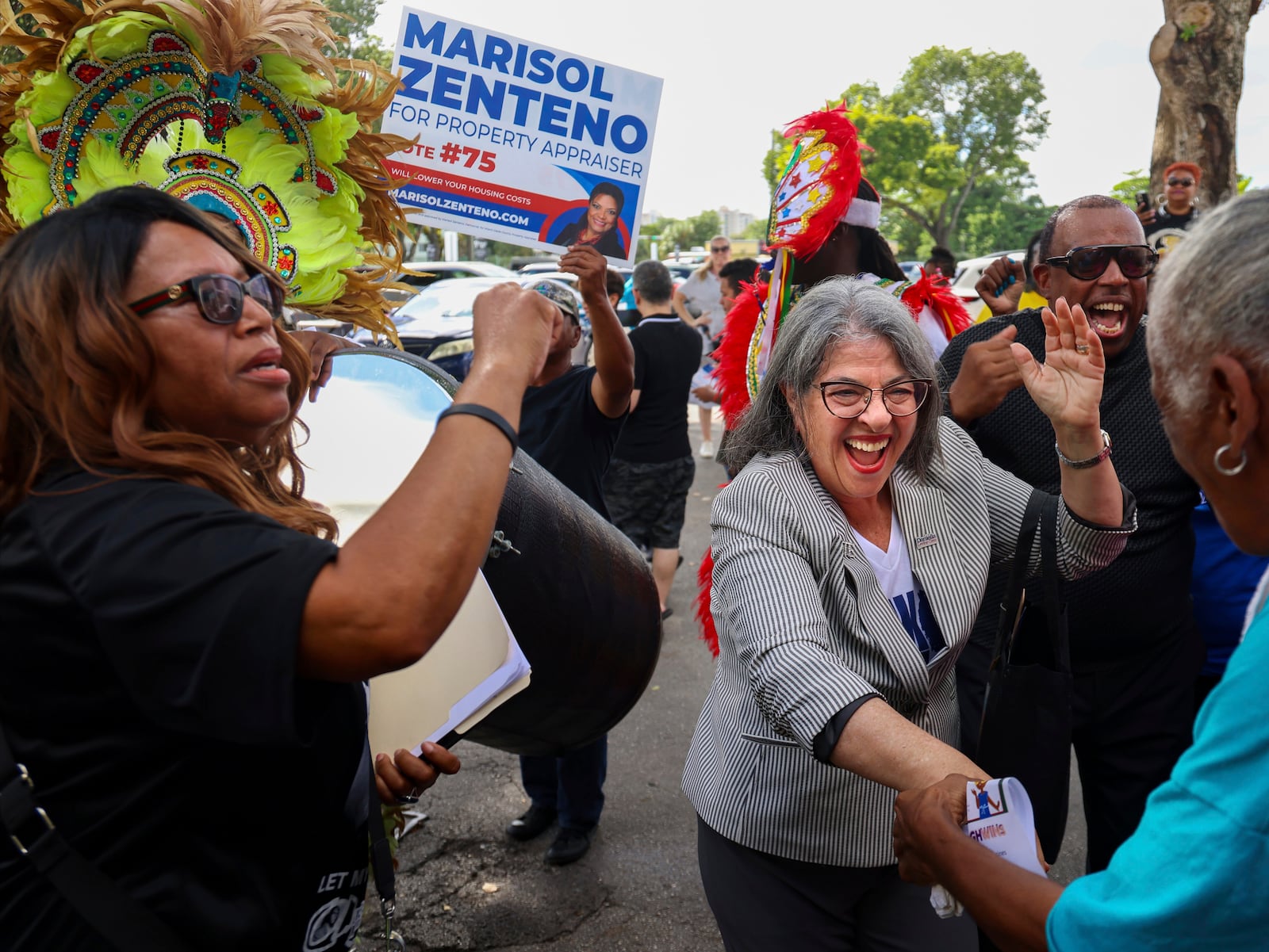 Democratic candidates, Mayor Daniella Levine Cava, right, and unincorporated Miami-Dade voters dance to the sounds of the Bahamian Junkanoo band during a festive visit to the polls at the Joseph Caleb Center during the "Souls to the Polls" event on the last day of early voting Sunday, Nov. 3, 2024, in Miami. (Carl Juste/Miami Herald via AP)