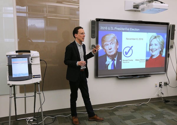 J. Alex Halderman prepares to demonstrate Monday at Georgia Tech how easy it is to hack Georgia’s electronic voting machines. In a hypothetical election, Halderman changed a 2-2 vote between George Washington and Benedict Arnold to make Arnold the winner by 3-1. Curtis Compton/ccompton@ajc.com