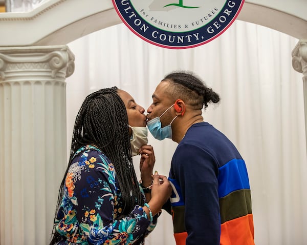 Newlyweds Tiffany Cableton and Brian Williams kiss after wedding ceremony at the Fulton County Courthouse in Atlanta last month. (Alyssa Pointer / Alyssa.Pointer@ajc.com)