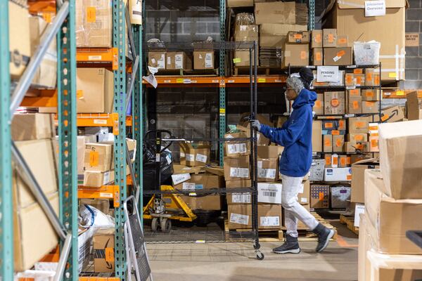 Bree Reid fulfills orders in the warehouse of ECOMSPACES in Atlanta on Friday, Dec. 8, 2023. (Arvin Temkar / arvin.temkar@ajc.com)