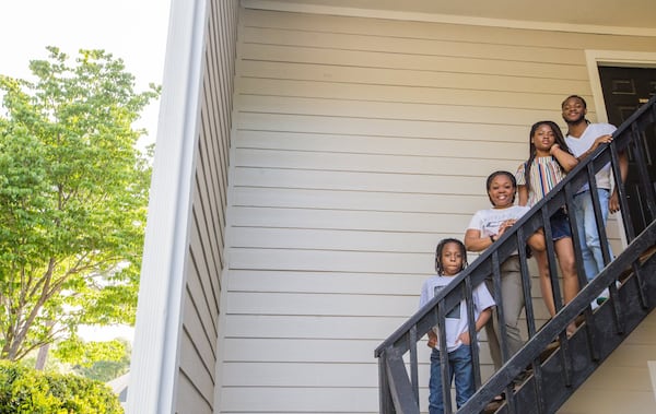 Outside their College Park apartment, Tiffany Ester (second from left) and her three kids, Roy, Jada and KK. (Jenni Girtman / For the AJC)