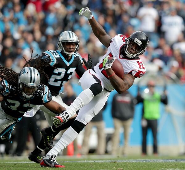 CHARLOTTE, NC - DECEMBER 24: Mohamed Sanu #12 of the Atlanta Falcons runs the ball against Tre Boston #33 and Leonard Johnson #23 of the Carolina Panthers in the 2nd quarter during their game at Bank of America Stadium on December 24, 2016 in Charlotte, North Carolina. (Photo by Streeter Lecka/Getty Images)