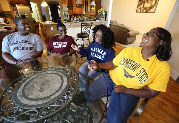 Donald Mason Jr. (from left), his wife Teresa Walker- Mason, and children, Deja, 17, and Delanie, 18, share a laugh at home in Dacula. Curtis Compton/ccompton@ajc.com