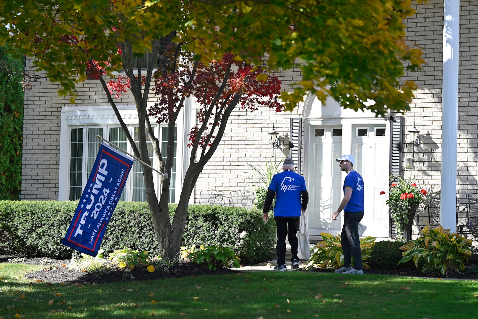 Republican Jewish Coalition members David Cuttner, left, and Noam Nedivi canvass a neighborhood, Sunday, Oct. 27, 2024, in West Bloomfield Township, Mich. (AP Photo/Jose Juarez)