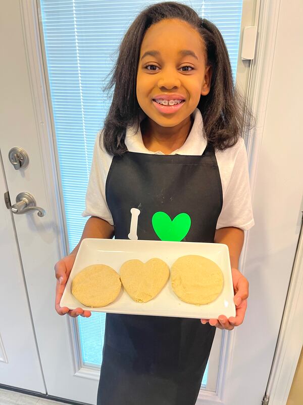 Lundyn Samuel proudly displays three of her finished Girl Scout Cookies. Courtesy of Michele Samuel