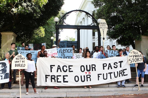 Current and former University of Georgia students, faculty and community activists gather at the Arch ahead of their march toward Baldwin Hall on May 6, 2019, in Athens. The demonstrators have pushed the school to offer various forms of reparations to address how, they say, the university has taken advantage of descendants of enslaved peoples, pay a higher working wage for university employees and give justice to the slaves who were found buried below Baldwin Hall. CONTRIBUTED BY CHRISTINA R. MATACOTTA