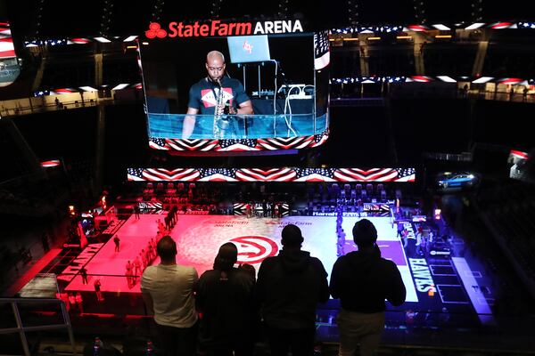 A few Atlanta Hawks fans watch their team take on the Philadelphia 76ers on Jan. 11. The NBA All-Star game will be held at the State Farm Arena on March 7, with expected attendance of 1,200 to 1,500. (Curtis Compton / Curtis.Compton@ajc.com)