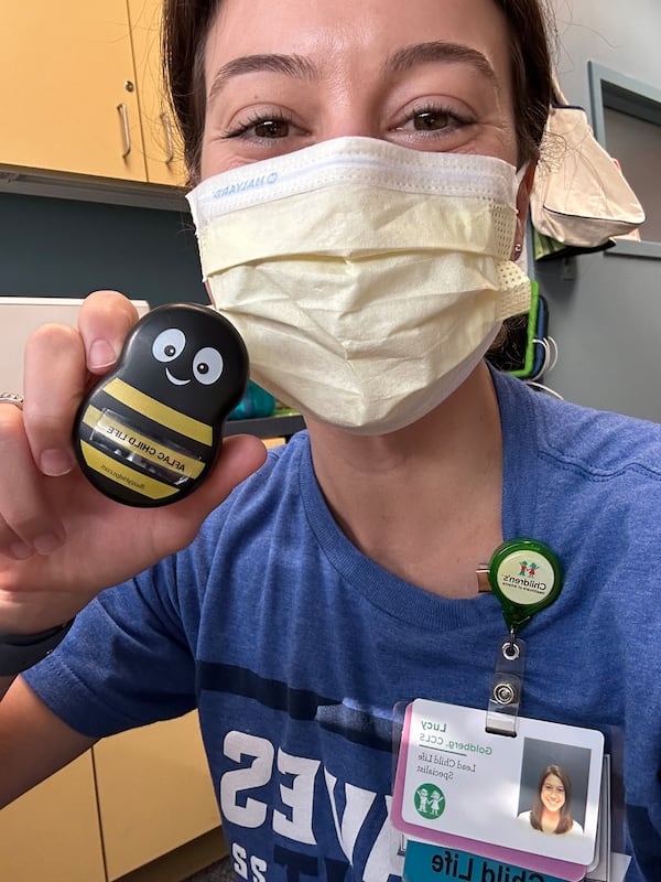 Child Life Specialist Lucy Goldberg shows off Buzzy, a non-pharmaceutical pain management device. Goldberg works in outpatient oncology at the Afac Cancer and Blood Disorders Center of Children's Healthcare of Atlanta Scottish Rite. Courtesy of Lucy Goldberg