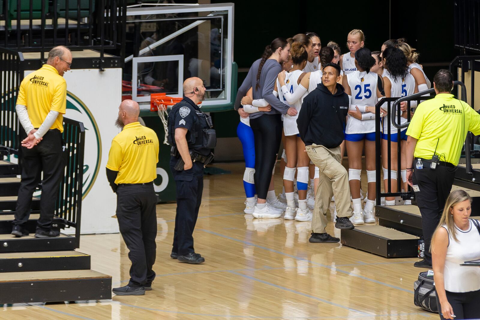 The San Jose State University Spartans are flanked by Moby Arena security, campus police and their own private guard during an NCAA Mountain West women's volleyball game against the Colorado State University Rams at Moby Arena in Fort Collins, Colo., on Thursday, Oct. 3, 2024. (Santiago Mejia/San Francisco Chronicle via AP)