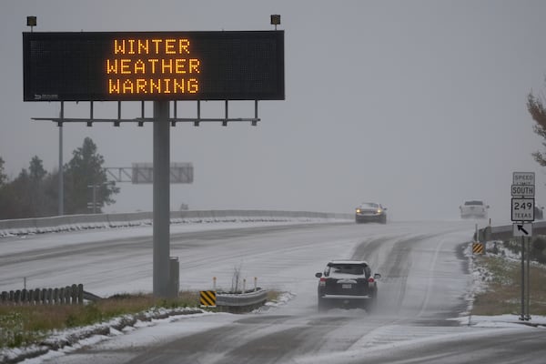 Cars travel on a snow covered highway Tuesday, Jan. 21, 2025, in Houston. (AP Photo/David J. Phillip)