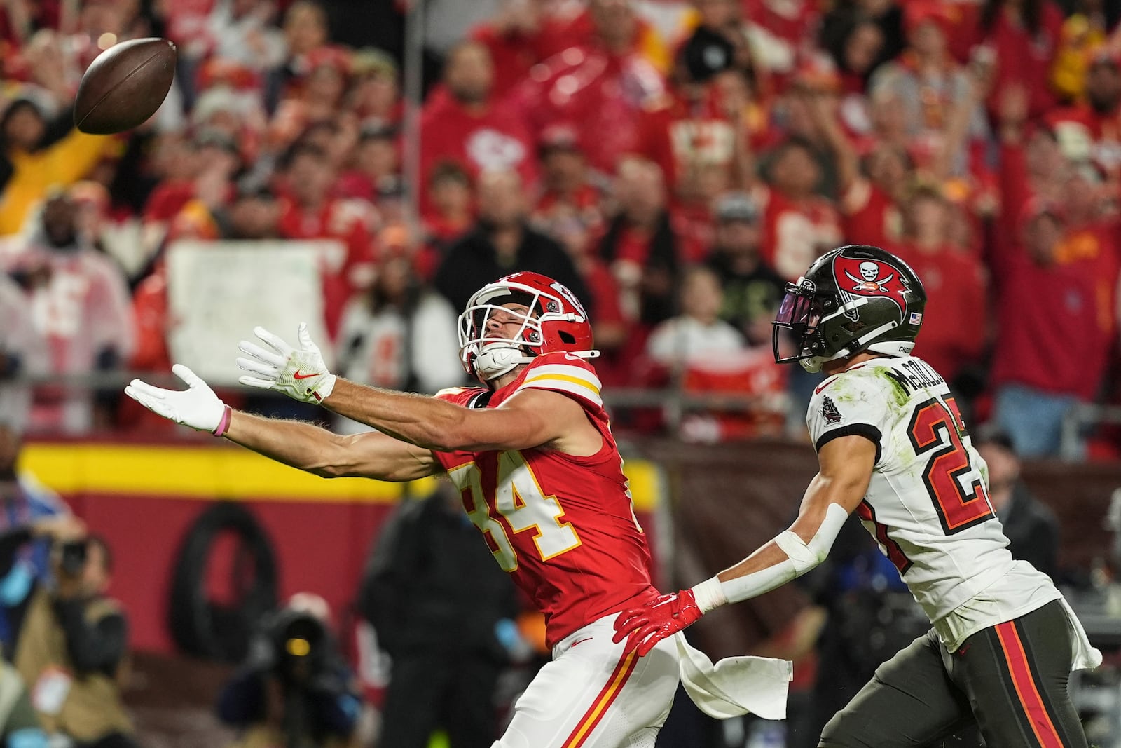 Kansas City Chiefs wide receiver Justin Watson (84) works for a catch against Tampa Bay Buccaneers cornerback Zyon McCollum (27) during the first half of an NFL football game, Monday, Nov. 4, 2024, in Kansas City, Mo. (AP Photo/Charlie Riedel)