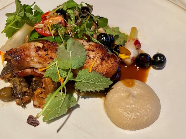 Falling Rabbit’s charred rabbit comes with morel and chanterelle conserva, sunflower crema, smoked blueberries, and a fresh, herby summer salad. 
Wendell Brock for The Atlanta Journal-Constitution