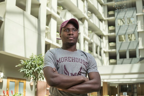 Morehouse College Economics senior Collins Kiplimo stands for a portrait in the lobby of his temporary residence at the Embassy Suites Hotel in downtown Atlanta, Thursday, April 16, 2020. Morehouse College is housing some of the students at the hotel as they finish out the semester. Kiplimo is from Kenya. (ALYSSA POINTER / ALYSSA.POINTER@AJC.COM)