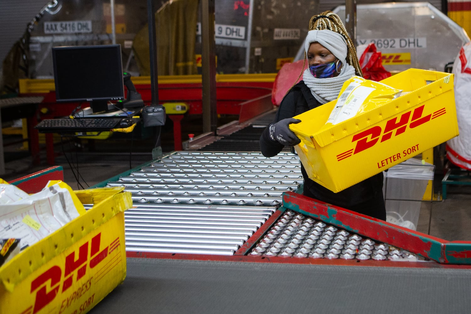 Shamika Thomas sorts packages on Wednesday, December 16, 2020, at DHL Express in Atlanta. Workers at the shipping center worked to fulfill orders during the holiday rush. CHRISTINA MATACOTTA FOR THE ATLANTA JOURNAL-CONSTITUTION.