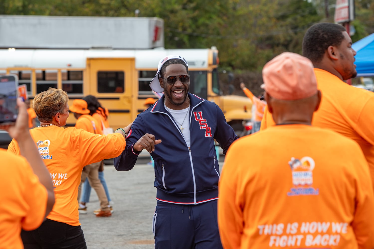 Young Dro, center, comes out to the last day of early voting in Georgia takes place at Metropolitan Library in South Fulton County on Friday, November 1, 2024.  The polling location had a steady stream of voters throughout the day.  (Jenni Girtman for The Atlanta Journal-Constitution)