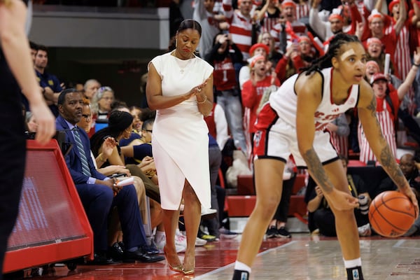 Notre Dame head coach Niele Ivey, center left, applauds in the final moments of an NCAA college basketball game against North Carolina State in Raleigh, N.C., Sunday, Feb. 23, 2025. (AP Photo/Ben McKeown)