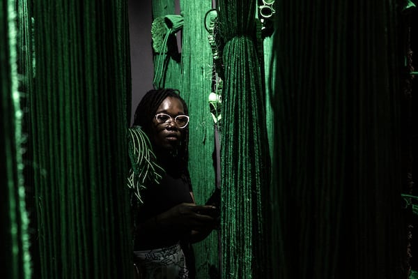 A visitor explores the international exhibit at the Dakar Biennale of Contemporary African Art in Dakar, Senegal, Friday, Nov. 8, 2024. (AP Photo/Annika Hammerschlag)