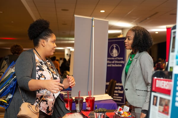 Georgia State is not alone in wanting to get more nonwhite and female students to teach on college campuses. Shonte Matthews, the assistant director of faculty and staff initiatives at the University of Georgia’s Office of Institutional Diversity, speaks to a conference attendee at the Marriott Marquis in downtown Atlanta on Friday, Oct. 25, 2019. An estimated 1,200 educators, college recruiters and students met at the Marriott Marquis this weekend as part of the Southern Regional Education Board-led Institute on Teaching and Mentoring. REBECCA WRIGHT / FOR THE ATLANTA JOURNAL-CONSTITUTION