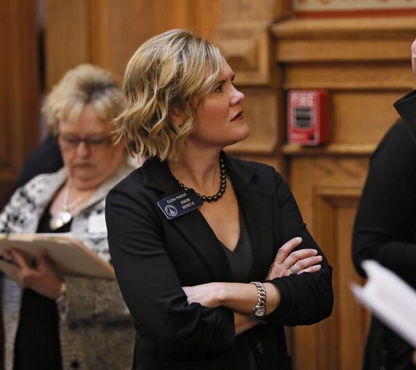 Sen. Elena Parent speaks with colleagues on the Senate floor as she objected to changes in adoption legislation Thursday. The Georgia Senate passed House Bill 159, relating to adoption, after two hours of debate. BOB ANDRES /BANDRES@AJC.COM