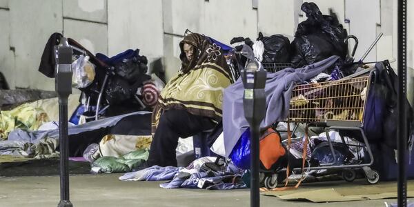 January 9, 2019 Atlanta: Mike Rore (center) just started staying on Bell Street under the downtown connector sleeping overnight with several other homeless people this week after he became dissatisfied with a local shelter. With forecasters warning of dangerous cold ahead this winter, the homeless population are vulnerable in the metro Atlanta area. While the number of persons who have succumb to the cold is less than last years count, there is still a long way to go before this winter is over and temperatures moderate. JOHN SPINK/JSPINK@AJC.COM