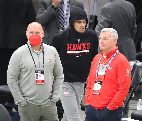 Hawks general manager and president Travis Schlenk (left) and owner Tony Ressler take in the scene as Hawks star Trae Young takes the court for warmups before playing the Milwaukee Bucks in Game 2 of the NBA Eastern Conference finals on Friday, June 25, 2021, in Milwaukee.   “Curtis Compton / Curtis.Compton@ajc.com”