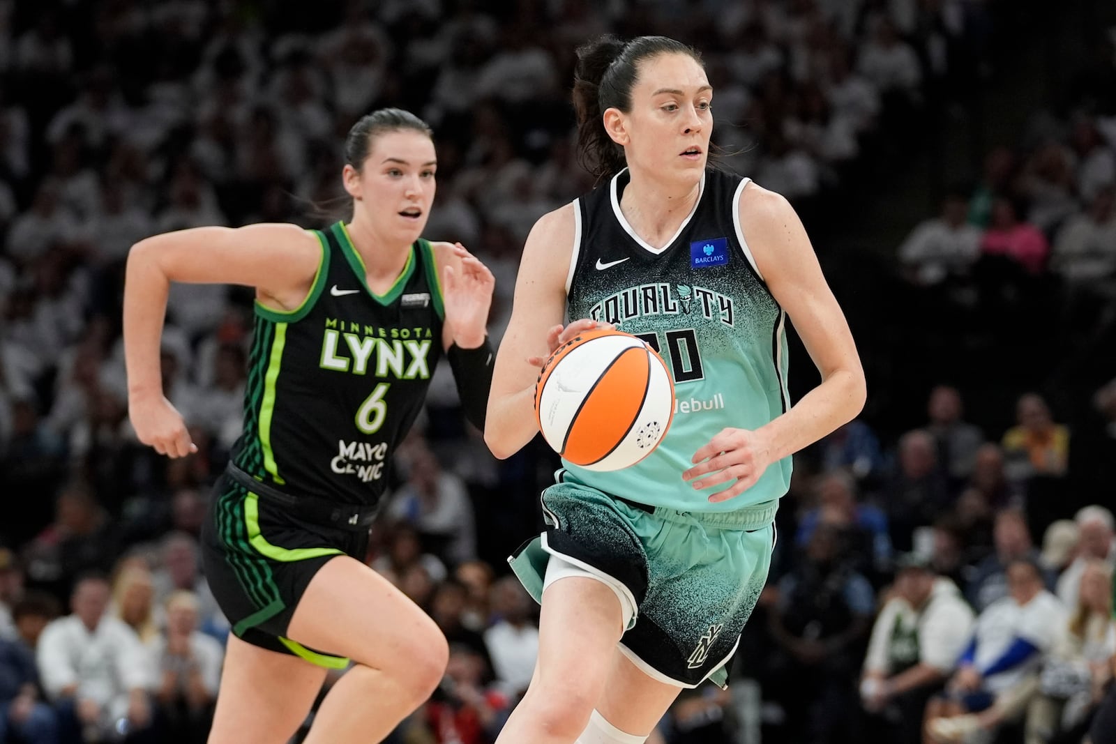 New York Liberty forward Breanna Stewart drives to the basket past Minnesota Lynx forward Bridget Carleton (6) during the first half of Game 4 of a WNBA basketball final playoff series, Friday, Oct. 18, 2024, in Minneapolis. (AP Photo/Abbie Parr)