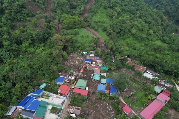 Rescuers work at the site after a recent landslide triggered by Tropical Storm Trami struck Talisay, Batangas province, Philippines leaving thousands homeless and several villagers dead on Saturday, Oct. 26, 2024. (AP Photo/Aaron Favila)