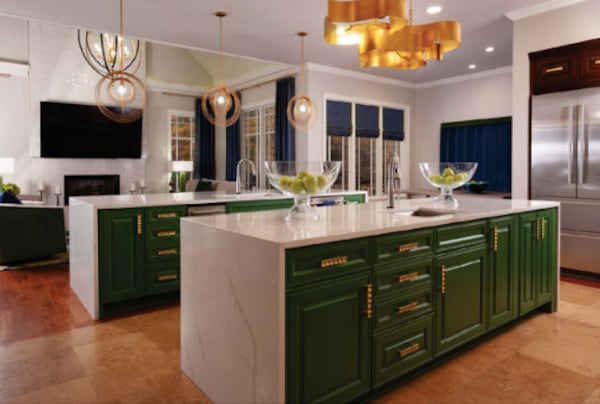 The sisters removed a row of cabinets above the island to open up the kitchen area and added new light fixtures and gold hardware to modernize the look.